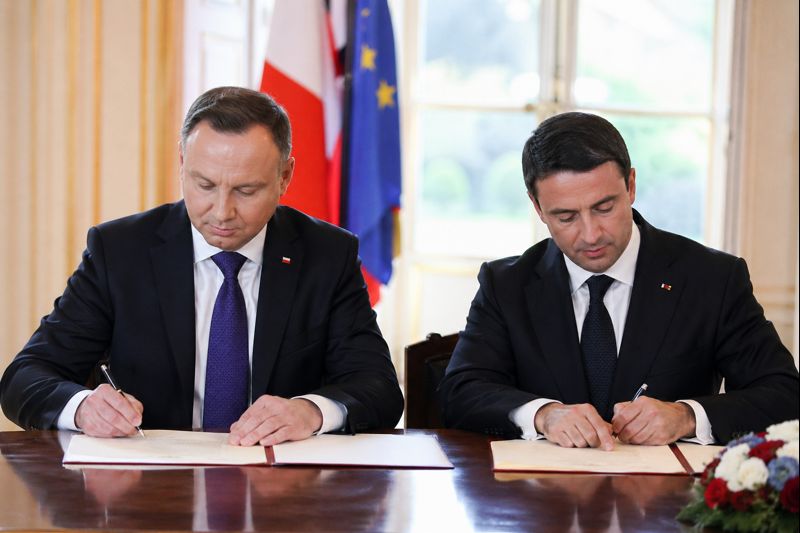 Government leaders signing economic nationalism trade protection policies in a formal setting